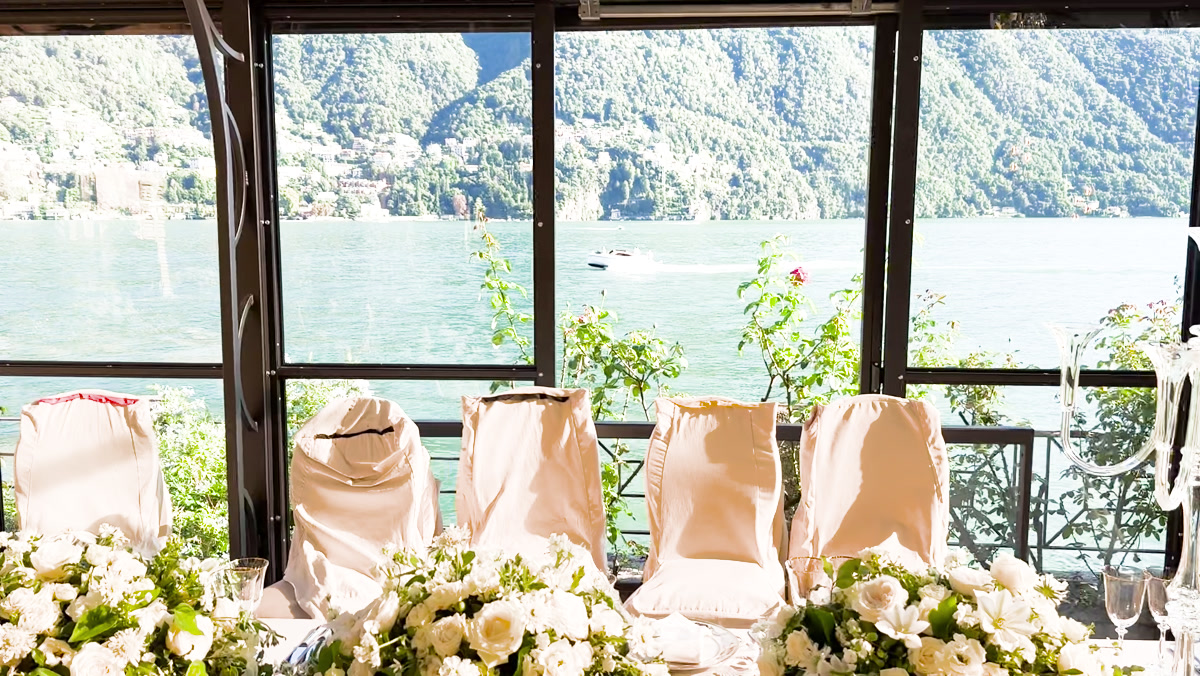 White wedding flowers and an elegant table overlooking Lake Como